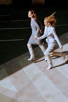 two women are walking down the street together