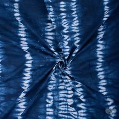 a blue tie - dyed fabric with white circles on the top and bottom, as if it were made from cloth