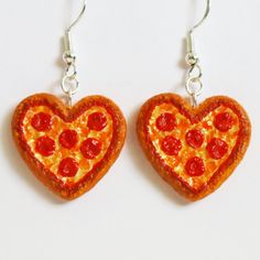 heart shaped pepperoni pizza earrings on white background