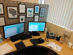 two computer monitors sitting on top of a desk next to a keyboard and mouse,