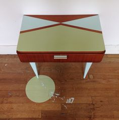 a wooden table sitting on top of a hard wood floor