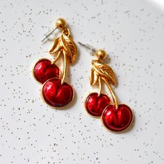 Adorable 1980's Avon cherry earrings with bright red glossy enamel over goldtone.  Era: circa 1980 Hallmark: Avon Measurements: 43mm by 21mm Cherry Color Dangle Earrings, Red Enamel Clip-on Jewelry, Vintage Red Enamel Earrings, Cherry Drop Earrings, Red Enamel Vintage Earrings, Vintage Enamel Clip-on Earrings, Vintage Gold Enamel Clip-on Earrings, Summer Cherries, Cherry Earrings