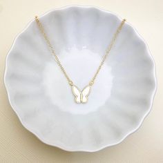 This beautiful mother of pearl and gold plated Butterfly pendant necklace is a perfect piece to incorporate gold into your everyday, casual style. Our quality hand-crafted bar necklaces are handmade with love and care and one at a time. ENTER OUR SHOP HERE for more beautiful jewelry : https://www.etsy.com/shop/MillyStreet Thank you for shopping with Milly Street! PLEASE READ OUR POLICIES https://www.etsy.com/shop/MillyStreet?ref=l2-shopheader-name#policies PLEASE READ OUR PRODUT CARE https://www Dainty Adjustable Gold Butterfly Necklace, Trendy White Charm Necklace For Gift, Everyday Gold Butterfly Necklace With Clavicle Chain, Dainty White Necklace For Gift, White Necklace With Adjustable Chain For Mother's Day, Delicate White Necklace For Mom, Trendy Butterfly Pendant Necklace For Gift, Trendy Butterfly Necklace With Adjustable Chain As Gift, White Delicate Chain Charm Necklace As A Gift