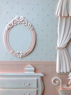 a dollhouse bedroom with white furniture and pink wallpaper on the walls, including a dresser