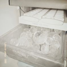 an ice tray filled with water next to a keyboard