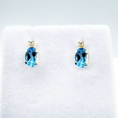 14K Yellow Gold Earrings Genuine Blue Topaz 1.2ct Size of stone: 6x4mm With Diamond 0.02ct Size of earrings: Length: 0.32″, Width: 0.15″ Made in Canada * Comes with 14K gold silicon clutches for cushioned comfort and loss prevention * Blue Topaz is the birthstone for December and known as the stone Tranquility * This item is available in several gemstone selections. Please message me if you need any further information. * Pendant matching with this item is available. * Comes in a Beautiful Gift Blue Diamond-accented 14k Gold Earrings, Blue Diamond Accent Earrings In 14k Gold, Blue Diamond Accent 14k Gold Earrings, Blue Oval 14k Gold Earrings, Oval Blue 14k Gold Earrings, Blue Oval Topaz Earrings, Blue Topaz Oval Earrings, December Birthstone Jewelry, Diamond Stud Earrings