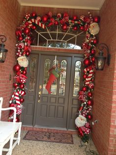 the front door is decorated for christmas with red and white ornaments