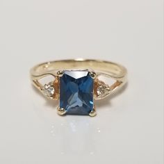 Thanks for shopping our vintage estate store. We tend to sell well below wholesale and truly hope you enjoy all of our items. Many of the items are one of a kind, so please enjoy scrolling through the pictures and hopefully something will catch your eye. Black spots are from the camera or reflections. Nice estate 10k yellow gold natural 1ct blue emerald cut topaz ring with .05ct diamonds in the setting. Beautiful older style ring. Topaz is testing natural. There are 2 diamonds in the setting. Ring size: 7.25 Setting: 1/4" 8mm by 11mm 3/8" Band width: 2mm Weight: 2.64 grams Gem: 6mm by 8mm Stunning ring, marked 10k. Gem is testing natural spinel or topaz, might be created but I do not think so. Classic Topaz Birthstone Ring For Gift, Classic Topaz Birthstone Ring With Center Stone, Classic Anniversary Topaz Birthstone Ring, Classic Sapphire Ring With Topaz Accent Stones, Classic Topaz Jewelry For Anniversary, Classic Topaz Diamond Ring With Accent Stones, Classic Diamond Ring With Accent Stones, Vintage Sapphire Topaz Promise Ring, Classic Blue Topaz Ring With Princess Cut