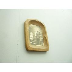 an old photo hanging on the wall with a wooden frame around it's edges