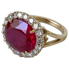 Gorgeous ring by Marina J. Absolute showstopper. This stunner features a large 9.98 carat enhanced Ruby which radiates magnificent hues of Reds and Fuchsias, bordered by a beautiful halo of 16 VS Diamonds, totaling 1.08 carats -  All set in solid 14k Yellow Gold. The shank itself comes in a classic double split style. Stamped 14k, this ring measures a women's size 7 (and can easily be sized up or down if requested.) For any questions or inquiries please email me!! Gold Chandelier Earrings, Ruby Diamond Rings, Vs Diamond, Ruby Earrings, Modern Ring, Exclusive Jewelry, Fancy Jewelry, Yellow Gold Chain, Ruby Diamond