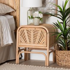 a wicker side table next to a bed