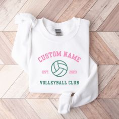 *SIZE GUIDE + MEASUREMENTS + COLORS are included in the listing photos. *ADDITIONAL BABY SIZES are available upon request. Elevate your everyday look with our Custom Volleyball Club Shirt.  Made from a breathable, luxuriously soft fabric with just the right amount of stretch. Featuring a crewneck style and a relaxed fit for a comfort that goes everywhere with you. The perfect essential or gift. T-SHIRT DETAILS: -Premium printed detail across chest -Premium airlume combed and ring-spun cotton -If you would like to adjust the design color, or would like a shirt color that isn't listed, we can make that happen for you! SWEATSHIRT DETAILS: -Premium cotton blend -Premium printed detail across chest -Finished with ribbed collar, cuff & hem -Brushed inner fleece for added softness -If you would l Volleyball Hoodie Design, White School Spirit Sweatshirt For Sports, White Sports Top With Custom Print, White Custom Print Sports Top, White Custom Print Sweatshirt For Sports Events, Collegiate White Sweatshirt For Sports, White Collegiate Sweatshirt For Sports, White Collegiate Style Sweatshirt For Sports, White Moisture-wicking Sweatshirt For Sports