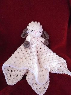 a crocheted sheep is wrapped in a blanket with the words, heffananoga patterns and afghan designs