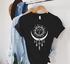 Celestial Sun and Moon Shirt, Mystical Sun T-shirt, Boho Summer Shirt, Yoga Outfit, Bohemian Gift Shirt, Spiritual Shirt, Astrology Lover Gift  HOW TO ORDER 1-) Please, check and review all the photos. 2-) Choose your t-shirt size and color. *Different styles of shirts may have different shades of the same color choice due to different manufacturer brands. *For this reason, we recommend matching shirts from the same styles if you want precisely matching colors (ex. Unisex, V-necks, Toddler, etc. Bohemian Summer Tops With Moon Print, Bohemian Short Sleeve Tops With Moon Print, Bohemian Moon Print Cotton Tops, Cotton Tops With Moon Print For Festival, Bohemian Cotton Tops With Moon Print, Bohemian Cotton Top With Moon Print, Bohemian Cotton T-shirt With Moon Print, Bohemian Tops With Moon Print Relaxed Fit, Sun And Moon Shirt