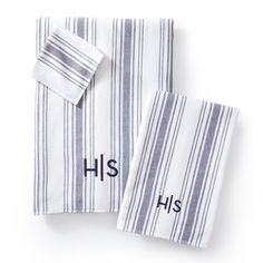 two white and blue striped towels with the words his and hers on them