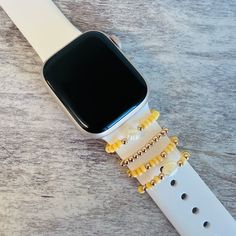 an apple watch with yellow beads on it