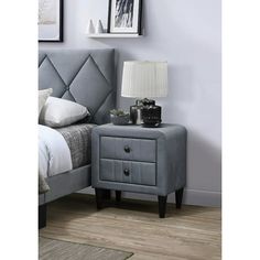 a bedroom scene with focus on the bed and bedside table, which has an upholstered headboard