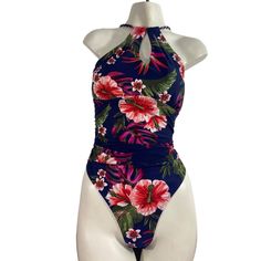 Embrace tropical vibes with the Kona Sol Women's Multicolored Floral One Piece Swimsuit in size L. This keyhole halter style bathing suit features a vibrant Hawaiian floral pattern on Feciclado material, perfect for any beach outing. All of our "without tags" swimsuits are carefully handpicked, with only those showing very minimal signs of wear making the cut. This particular swimsuit is in excellent condition, almost like new. Please refer to the pictures for details. Measurements can be found Tropical Halter Neck Tankini For Pool, Tropical Halter Neck Top For Poolside, Floral Print Halter Neck Tankini For Swimming, Tropical Print Halter Top For Beach Season Poolside, Tropical Print Halter Top For Poolside And Beach Season, Beachwear Halter Top With Tropical Print For Poolside, Fitted Tropical Print Halter Neck Tankini, Summer Tropical Print Halter Neck Swimwear, Beach Season Tropical Print Halter Top For Pool