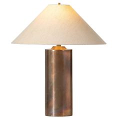 a table lamp with a white shade on it's base and a gold finish