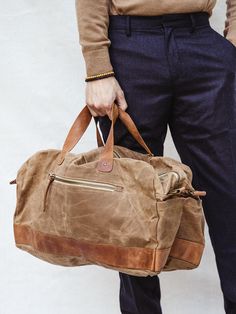 Say hello to your new getaway go-to! This spacious weekender bag is hand-crafted with durable canvas and genuine leather – that means it’s made to last, whether it’s a long weekend away or a two week trip to Paris (even with baggage handling!) And say goodbye to shoulder aches once and for all, no matter how long that airport line is — an adjustable strap configuration offers multiple ways to carry this bag. Throw it over your shoulder with the adjustable shoulder strap, grab the top carry handl Brown Waxed Finish Weekender Tote Bag, Rectangular Weekender Bag With Luggage Sleeve, Beige Weekender Bag With Leather Handles For Weekend Trips, Weekend Bag With Canvas Lining, Beige Leather Duffle Bag For Weekend Trips, Leather Weekender Bag With Large Capacity, Leather Weekender Bag With Leather Trim For Travel, Brown Canvas Duffle Bag With Leather Handles, Weekender Bag With Leather Trim For Everyday Use