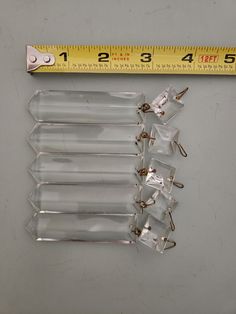 several clear plastic clips with a measuring tape in the background