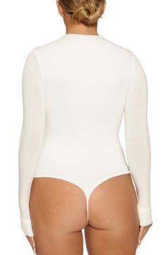 Start your look off right with this thong bodysuit that fits like a second skin and is shaped with a high neckline and extra-long sleeves. Exclusive retailer Snap closure Funnel neck Long sleeves Lined 95% viscose, 5% spandex Hand wash, line dry Made in the USA or imported Women's Clothing Long Sleeve Stretch Bodysuit With Smoothing Details, Long Sleeve Second-skin Smoothing Bodysuit, High Stretch Long Sleeve Bodysuit With Lined Body, High Stretch Long Sleeve Lined Bodysuit, Fitted High Cut Smoothing Bodysuit, Second-skin Long Sleeve Bodysuit With Lined Body, Smoothing Fitted High Cut Bodysuit, Smoothing Fitted High-cut Bodysuit, Second-skin Long Sleeve Lined Bodysuit