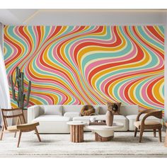 a living room filled with furniture and a colorful wall mural on the wall behind it