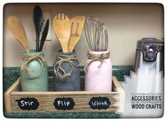 kitchen utensils and wooden spoons are in a tray