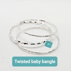 Twisted bangle bracelet- Baby Bracelet-Gold Baby Bangle Bracelet - 1st baby birthday present - 2 bangles for baby girl - newborn gift This listing is priced for 2 Twisted baby bangles. If you order more than 1 pair, please add note to seller of the different sizes and materials you would like. Bangles come in 4 different sizes: Newborn =4.5 inch circumference = approximately 1.5 inch diameter Crawler= 5 inch circumference = approximately 2 inch diameter Toddler/Walker = 6 inch circumference = ap Adjustable Silver Bangle For Birthdays, Adjustable Silver Bangle For Birthday, Adjustable Hypoallergenic Bracelet For First Birthday, Hypoallergenic Bangle Jewelry For Birthday, Adjustable Bangle For Birthday, Stackable Round Bracelets For Birthday, Baby Bracelet Gold, Newborn Baby Girl Gifts, Baby Bangles