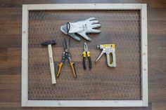 tools are laid out on top of a chicken wire mesh tray, including gloves and pliers