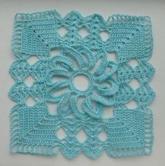 a crocheted doily is shown on a white surface