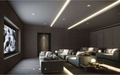 a large room with couches, tables and lamps on the walls is lit by recessed lights