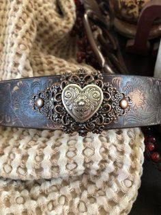 "🔸🔸orders are delayed by a few days this week. Thank you for your patience Heart leather bracelet cuff, western jewelry Embossed distressed new genuine 1 1/2\" brown leather strap has been adorned with an antiqued silver heart concho which sets on two copper flower filgrees which have been riveted to the leather with two copper rivets. One antiqued copper snap has been added to fit up to a 7 1/4\" wrist. I can add another snap for a smaller or larger size but you need to convo be before purcha Western Style Brown Cuff Bracelet As Gift, Brown Concho Bracelets As Gift, Handmade Vintage Bracelets For Valentine's Day, Adjustable Concho Cuff Bracelet Gift, Brown Western Style Leather Bracelet, Western Style Brown Leather Bracelet, Brown Western Style Leather Bracelet Gift, Western Style Engraved Bracelets For Gifts, Western Hand Tooled Cuff Bracelet As Gift