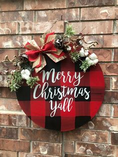 a merry christmas yall sign hanging on a brick wall