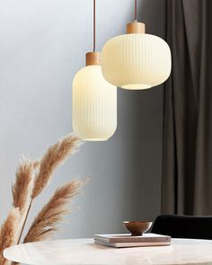 three lamps hanging over a table in a room