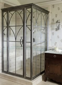 a bathroom with a stand up shower next to a sink