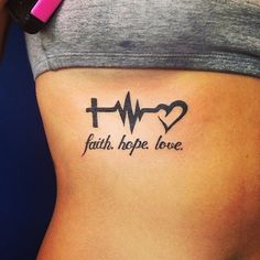 a woman's stomach with the words faith hope love and heartbeat tattoo on it