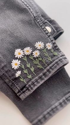 daisies embroidered on the back of jeans