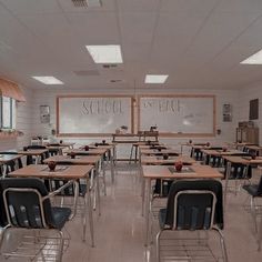 an empty classroom with desks and chairs