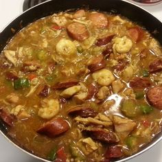 a pan filled with food sitting on top of a stove