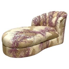 an upholstered chaise lounge chair with purple flowers on the back and arms