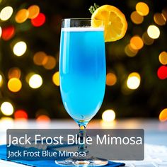 jack frost blue mimosa is served in a tall glass with a slice of lemon on the rim