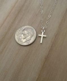 Similar items: ALLDANAE.etsy.com Please read my shop policies before ordering: https://www.etsy.com/shop/AllDanae#policies A small, simple cross necklace in all .925 sterling silver materials. Not including the loop, the cross measures approximately 3/8 inch high, and 1/4 inch wide (about 9mm X 6mm). The cross is small and understated, yet solid and very study. The smooth, unadorned silver goes effortlessly with whatever you are wearing. Your necklace can be made long or short. Choose your prefe Everyday Silver Crucifix Jewelry, Silver Crucifix Jewelry For Everyday Wear, Minimalist Hypoallergenic Cross Jewelry, Dainty Silver Crucifix Jewelry, Everyday Silver Cross Pendant Necklace, Hypoallergenic Cross Jewelry For Everyday, Simple Everyday Cross Pendant Necklace, Silver Crucifix Cross Necklace For Everyday, Minimalist Silver Cross Necklace