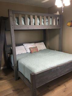 a wooden bunk bed sitting on top of a hard wood floor