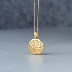 "Solid gold cross necklace, ICXC NIKA necklace (meaning: \"Jesus Christ conquers\"), Constantine disc, protection charm. One side of the cross features a cross with the initials ICXC and on the other side an engraving of Saint Constantine and Saint Helena. Can be worn on either side. The pendant is available in 14k yellow, shiny finish. You can purchase the charm with a 14k gold filled chain for the yellow and rose disc, a white gold plated sterling silver chain for the white gold disc, a 14k so Gold Coin Necklace With Large Symbolic Pendant, Commemoration Necklace With Large Round Pendant, Gold Byzantine Medallion Necklace, Gold Cross Amulet Necklace, Gold Byzantine Tarnish Resistant Necklace, Gold Round Pendant Necklace For Commemoration, Gold Byzantine Tarnish-resistant Necklace, Gold Byzantine Necklace With Round Pendant, Gold Byzantine Round Pendant Necklace