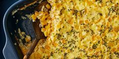 a casserole dish with broccoli and cheese on it, ready to be eaten