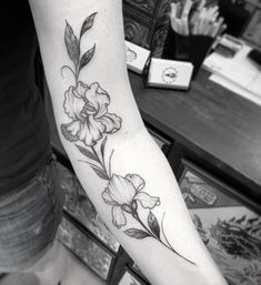 a black and white photo of a flower on the arm