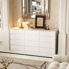 a living room with a white dresser and mirror