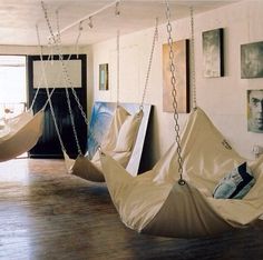 there are two hammocks hanging in the room