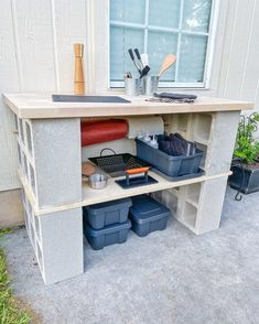 an outdoor kitchen with pots, pans and utensils